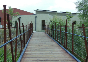 Recycled railroad flat car bridge